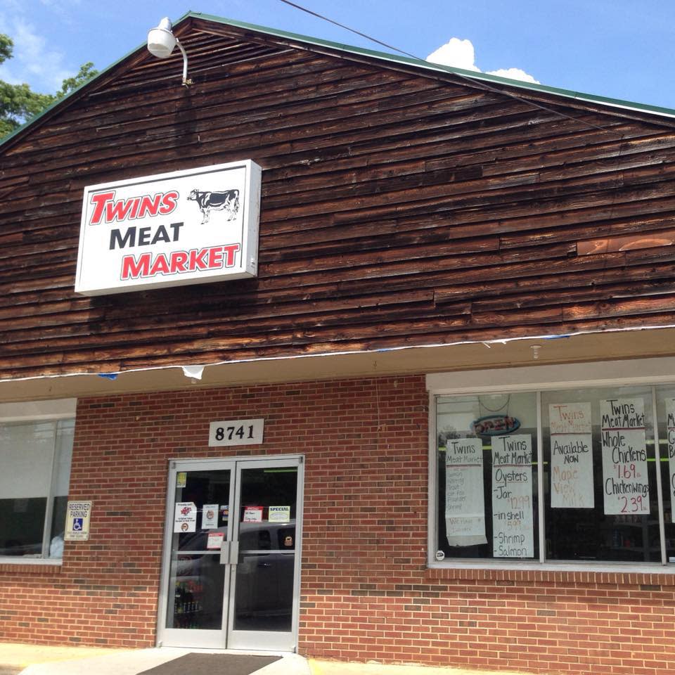 Entrance to the Twins Meat Market in a red brick building
